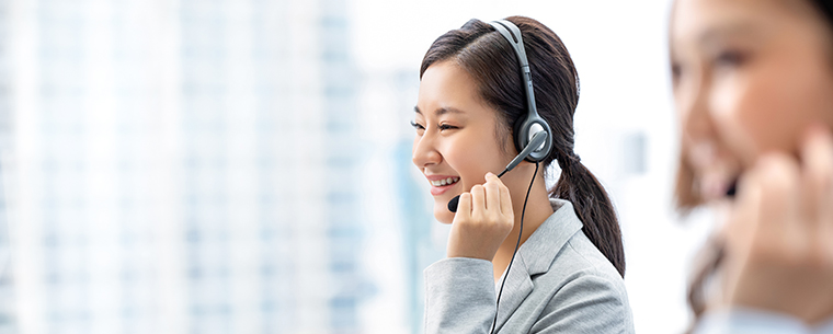 Young woman talking on a phone headset